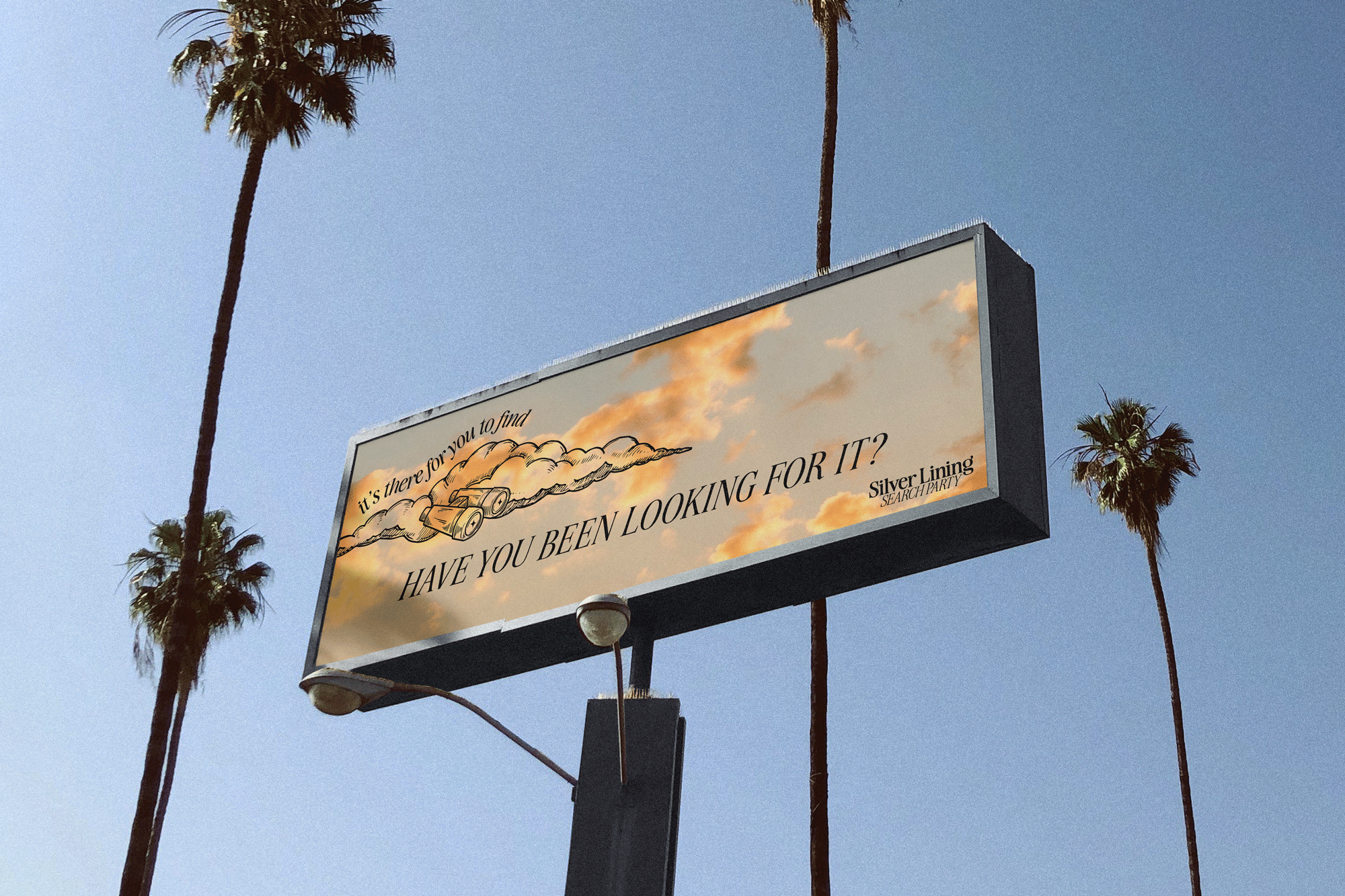 billboard for Silver Lining Search Party surrounded by blue sky and tall palm trees
